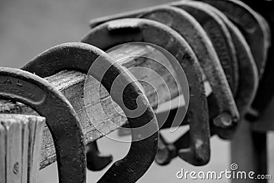 Old horseshoes on fence Stock Photo