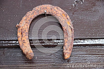 an old horseshoe hanging on a nail, luckily Stock Photo