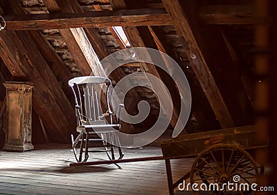 Old house attic with retro furniture, wooden rocking chair. Abandoned home concept Stock Photo