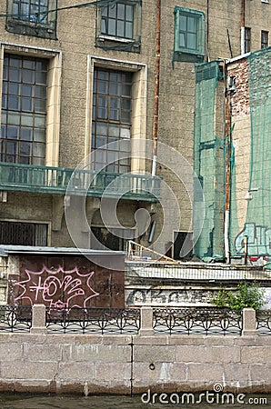 Old house covered green facade mesh Stock Photo