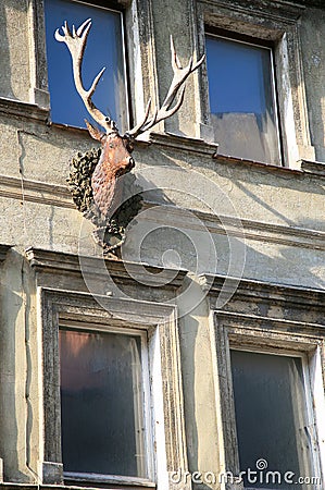 Old house facade with deer head and horns Stock Photo