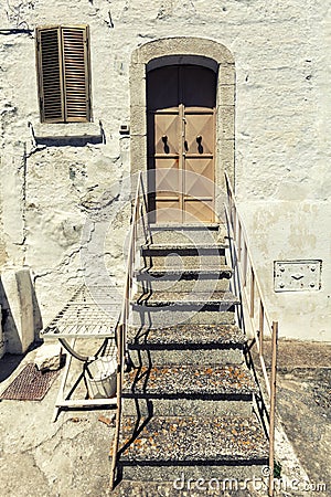 Old house front door and stairs. Vintage Italian scene Stock Photo