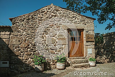 Old house with stone wall and wooden door Editorial Stock Photo