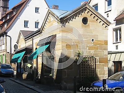 Old houses and architecture in a German city, Europe. Small shops and cars near them Stock Photo