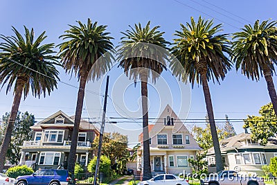 Old houses and palm trees on a street in downtown San Jose, California Stock Photo