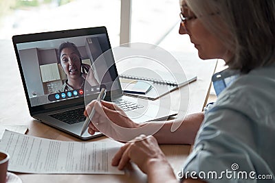 Old hr checking cv interviewing indian female job applicant by video call. Stock Photo