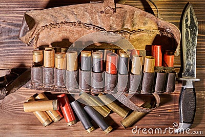 Old hunting cartridges and bandoleer on a wooden table Stock Photo