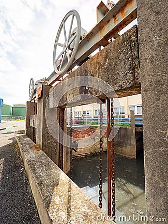 Old hydraulic closure system in sewage channel Stock Photo