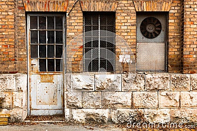 Old industrial building exterior wall, door and window Stock Photo