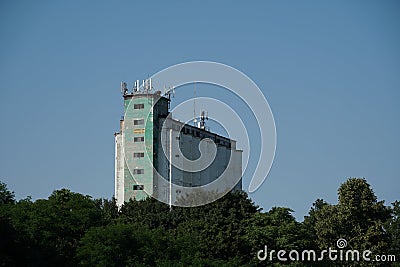 Old industrial building in a provincial town in Eastern Europe with aerials and antennas places on the rooftop enabling better sig Stock Photo