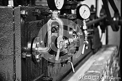 Black and white Old Industrial Machine pressure gauge and pipes Stock Photo