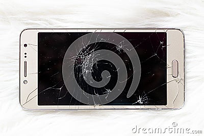 An old iPhone with a broken black screen on a white background Editorial Stock Photo