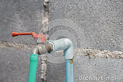 Old iron faucet with rubber band Stock Photo