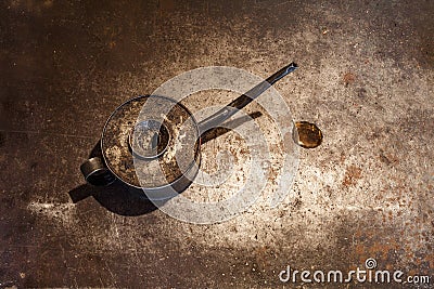 The old iron oiler and the spot of lube oil on the metal background Stock Photo