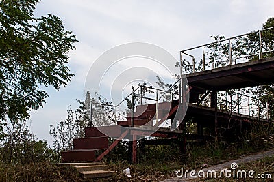 Old iron stairs that are going to rust in the woods. Stock Photo