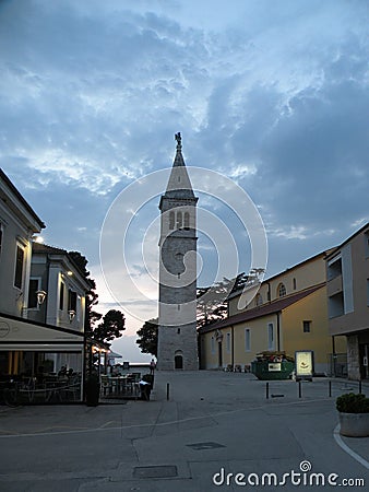 Old Istrian town of Novigrad, Croatia. A beautiful church with a high elegant bell tower, stone alleys and old Mediterranean house Editorial Stock Photo