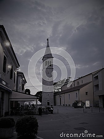 Old Istrian town of Novigrad, Croatia. A beautiful church with a high elegant bell tower, stone alleys and old Mediterranean house Editorial Stock Photo