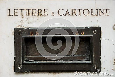 Old italian postbox on ancient marble wall of house in metal, symbol of vintage correspondence and mail Stock Photo