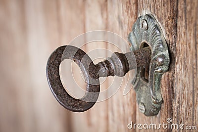 Old key in a keyhole Stock Photo