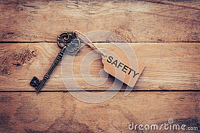 Old key and tag lable SAFETY for on wooden for business concept. Stock Photo