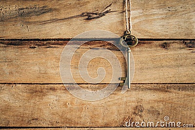 Old key vintage hanging on wooden background Stock Photo