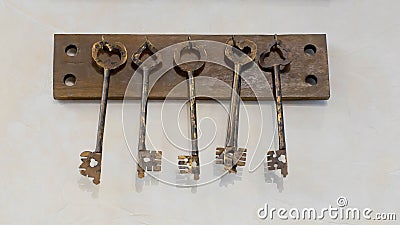 Old keys with key hanging on a white wall of an old hotel Stock Photo