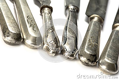Old knife handles made of silver of various cutlery, isolated on Stock Photo