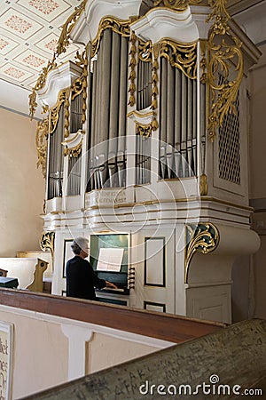 Old lady playing medieval church organ Editorial Stock Photo