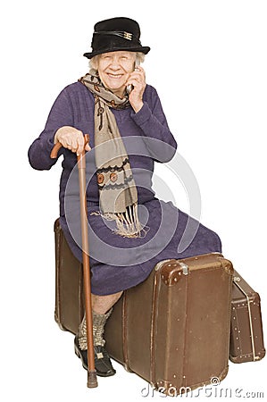 The old lady sits on a suitcase Stock Photo