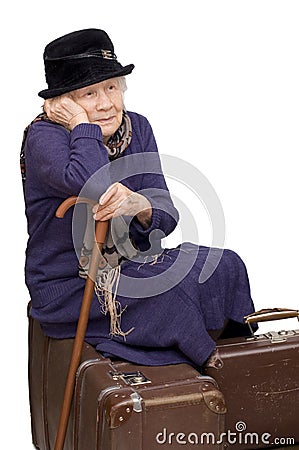 The old lady sits on a suitcase Stock Photo