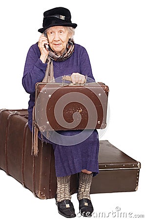 The old lady sits on a suitcase Stock Photo