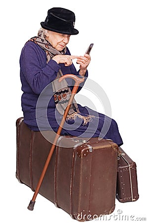 The old lady sits on a suitcase Stock Photo