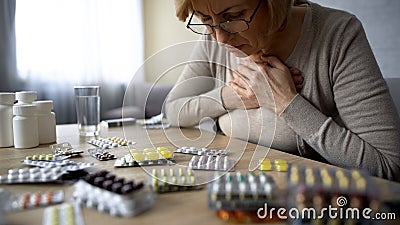 Old lady taken too much pills, feeling unwell, heart problem, self-medication Stock Photo