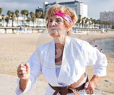 Mature woman running on beach Stock Photo