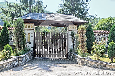 The old Lainici Monastery on a summers day, detail of entrance gate. Editorial Stock Photo