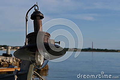 Old lamp for night deep-sea fishing installed on fisherman boat. Stock Photo