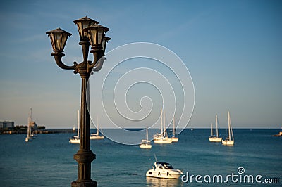 Old lamp in quiet harbor Stock Photo