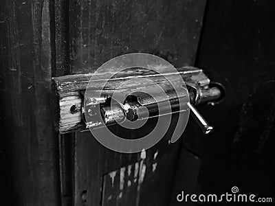 Old latch or heck on a wooden door Stock Photo