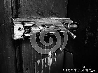 Old latch or heck on a wooden door Stock Photo