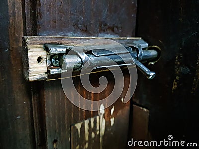 Old latch or heck on a wooden door Stock Photo