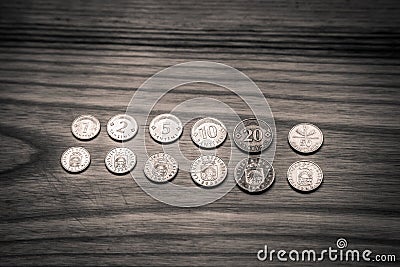 Old Latvian coins on a wooden background - monochrome vintage lo Stock Photo