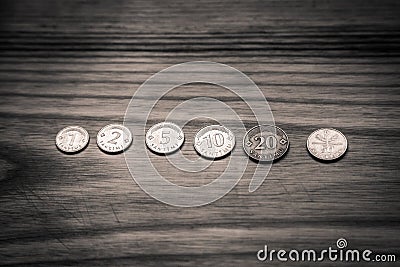 Old Latvian coins on a wooden background - monochrome vintage lo Stock Photo