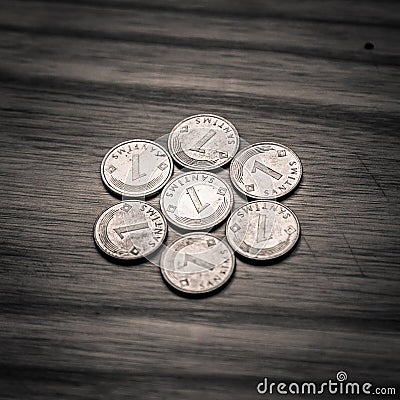 Old Latvian coins on a wooden background - monochrome vintage lo Stock Photo