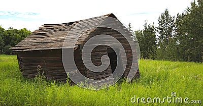 Old leaning farm shed Stock Photo