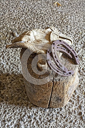 Old Leather Work gloves and Horse Shoes Stock Photo