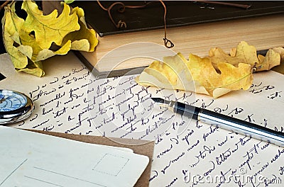 Old letter, pen, book and yellow leaves Stock Photo