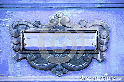 Old letterbox or mailbox in the gate door traditional way of delivering letters or mail to the house address close up Stock Photo