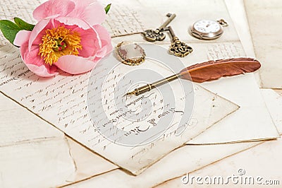 Old letters, pink peony flower and antique feather pen. Vintage Stock Photo