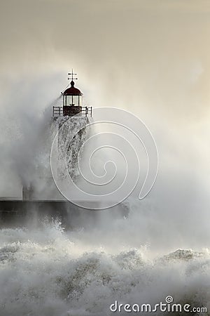 Old lighthouse during heavy ocean storm Stock Photo