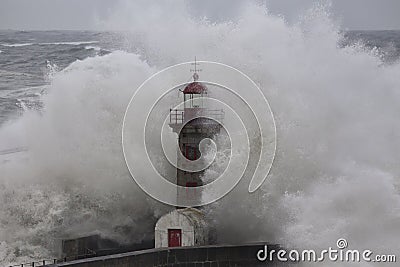 Old lighthouse in the middle of stormy waves Stock Photo